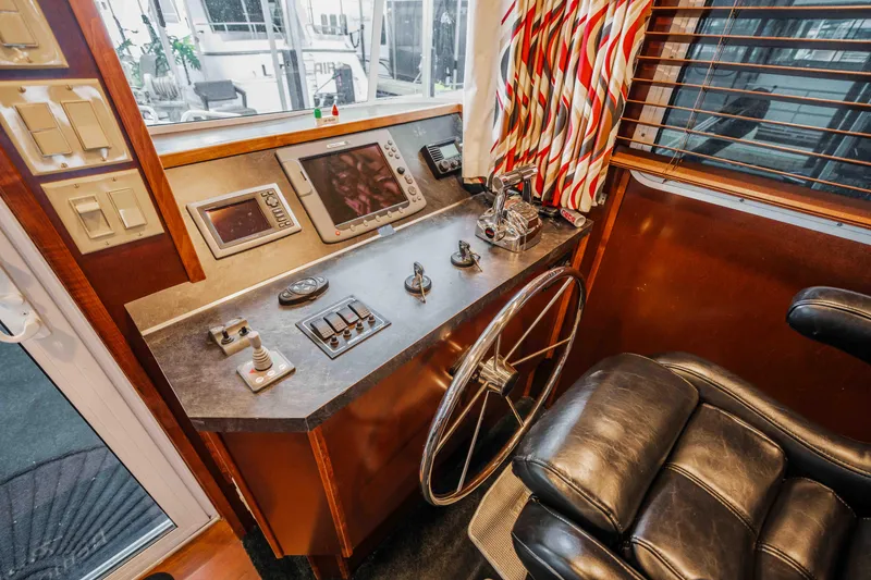 Slide: The Image of Control panel of a 2008 Monticello Houseboat with steering wheel and navigation equipment. - 44