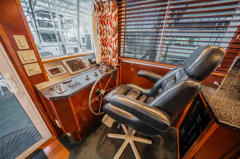 Slide: The Image of Luxurious 2008 Monticello houseboat helm with leather captain's chair and modern controls. - 45