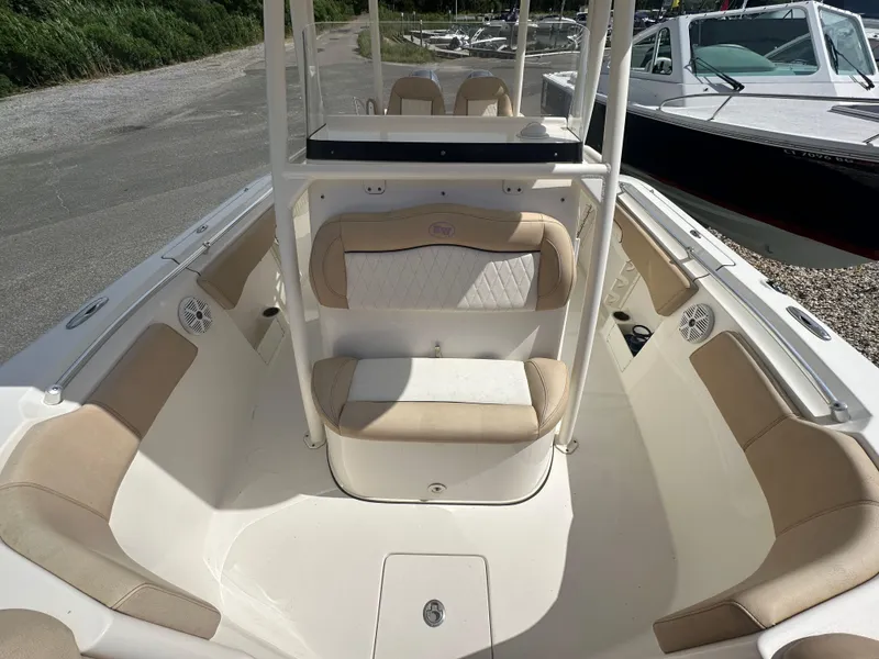 Slide: The Image of 2019 Key West 263 FS boat interior with beige seating and white deck. - 13