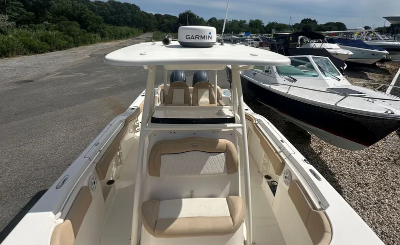 Slide: The Image of 2019 Key West 263 FS boat with Garmin equipment, docked alongside other boats. - 14