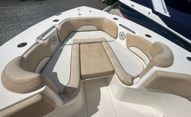 Slide: The Image of 2019 Key West 263 FS boat interior with beige cushioned seating and cup holders. - 16