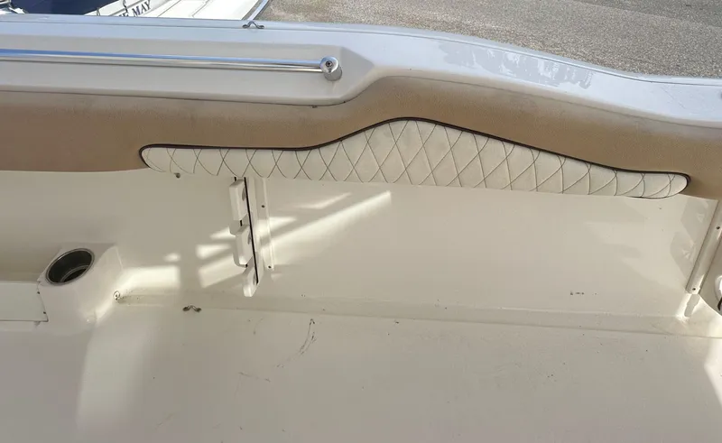 Slide: The Image of Interior of 2019 Key West 263 FS boat with cushioned seating and cup holder. - 18