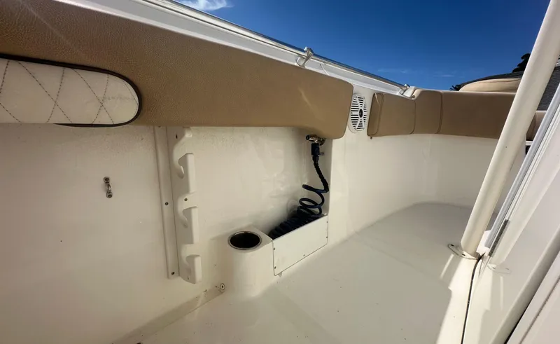 Slide: The Image of 2019 Key West 263 FS boat interior with cushioned seating and storage compartments. - 19