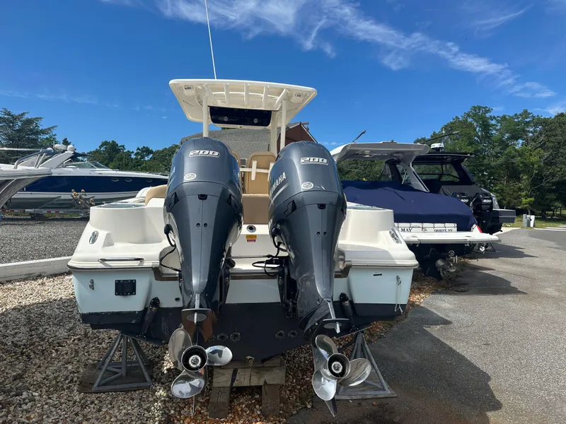 Slide: The Image of 2019 Key West 263 FS boat with dual Yamaha outboard engines, parked on a sunny day. - 3