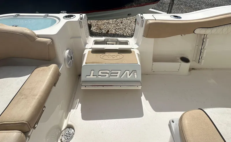 Slide: The Image of 2019 Key West 263 FS boat interior with beige seating and storage compartments. - 6