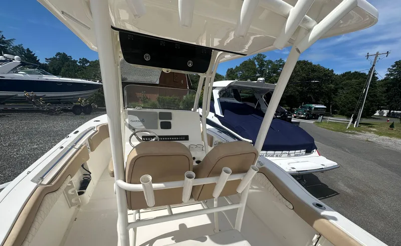 Slide: The Image of 2019 Key West 263 FS boat interior with helm and seating, parked outdoors. - 7