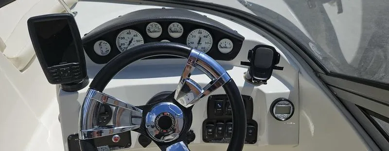 Slide: The Image of Dashboard of a 2016 Stingray 225RX boat with steering wheel and gauges. - 10