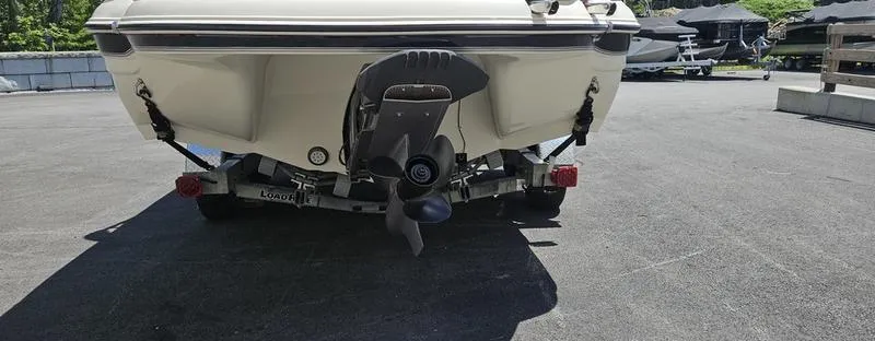 Slide: The Image of Rear view of a 2016 Stingray 225RX boat on a trailer in a parking area. - 21