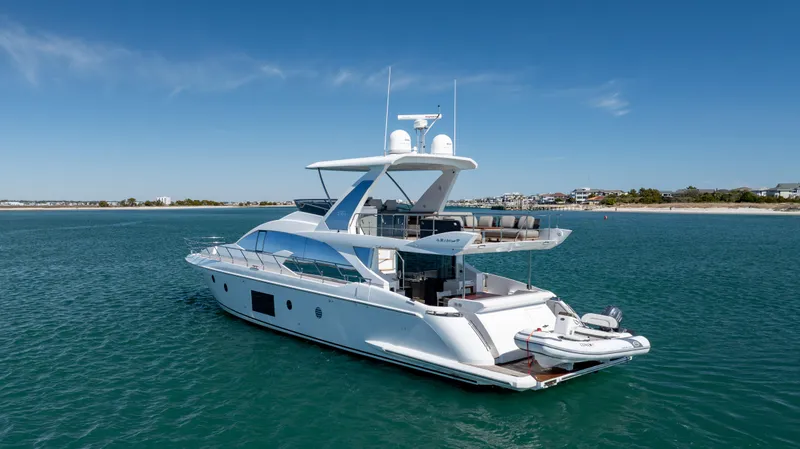 Slide: The Image of 2019 Azimut 66 FLY yacht on calm blue waters, clear sky background. - 10