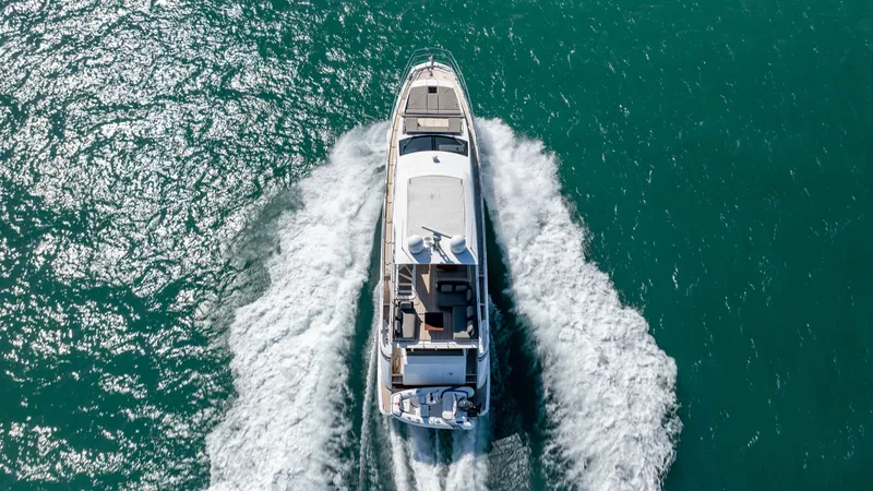 Slide: The Image of Aerial view of 2019 Azimut 66 FLY yacht cruising on turquoise water. - 11