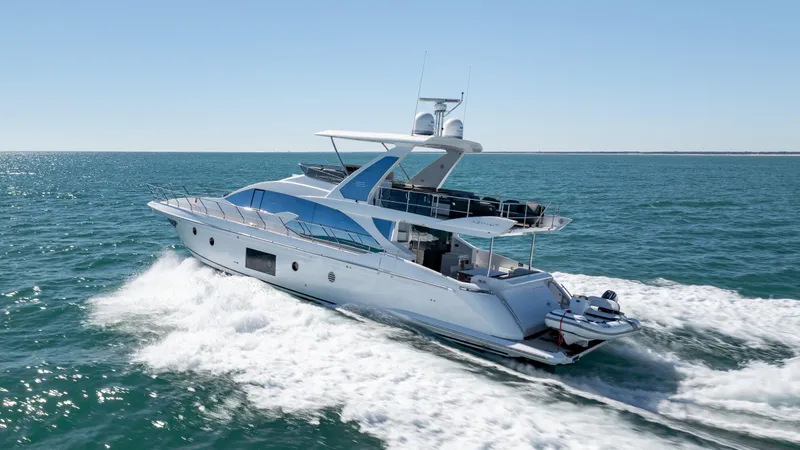Slide: The Image of 2019 Azimut 66 FLY yacht cruising on open sea, showcasing sleek design and luxury. - 12