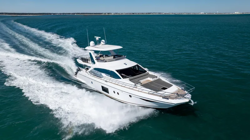 Slide: The Image of 2019 Azimut 66 FLY yacht cruising on open water, creating a dynamic wake. - 14