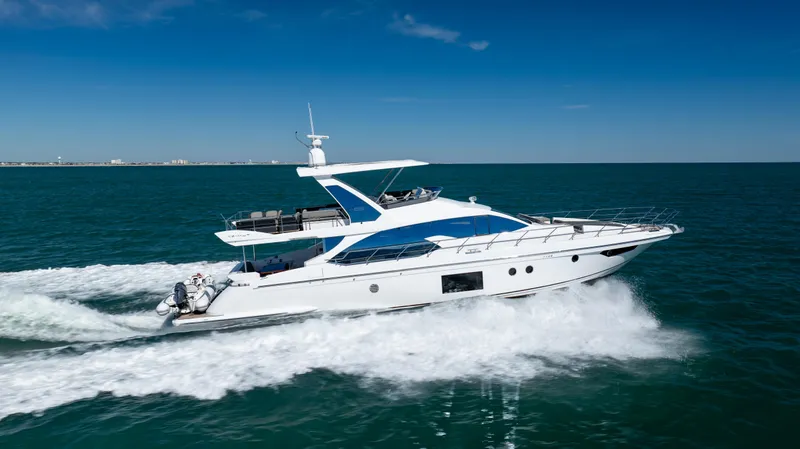 Slide: The Image of 2019 Azimut 66 FLY yacht cruising on open sea under clear blue sky. - 8