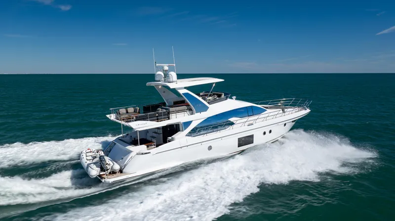 Slide: The Image of 2019 Azimut 66 FLY yacht cruising on open sea under clear blue sky. - 9