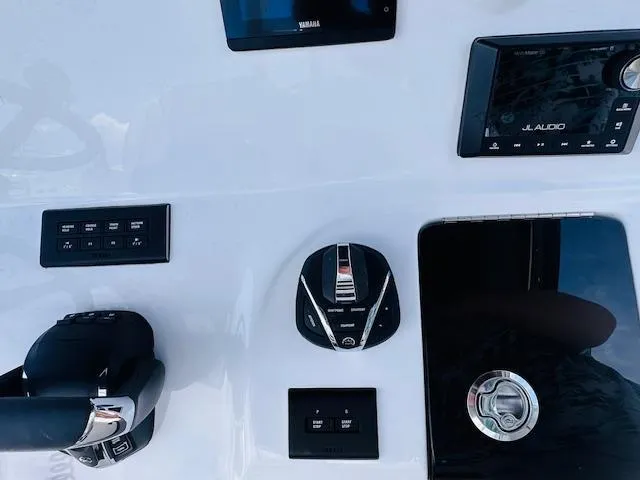 Slide: The Image of Control panel of 2026 Tidewater 302 CC Adventure boat with modern navigation and audio systems. - 9