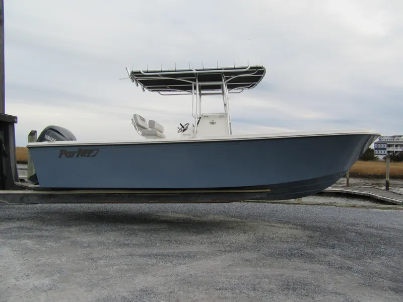 The Image of 2025 Parker 23SE Center Console boat on a lift, side view, with Yamaha engine. - 1