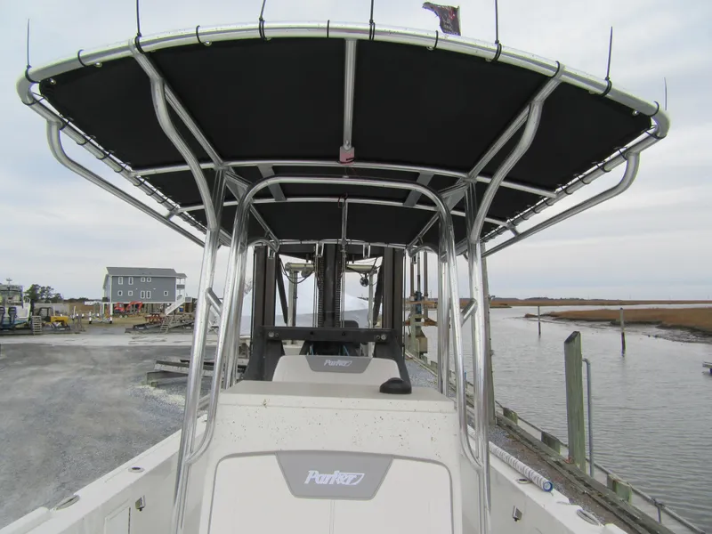 Slide: The Image of 2025 Parker 23SE Center Console boat docked by a waterfront, showcasing its sleek design. - 10