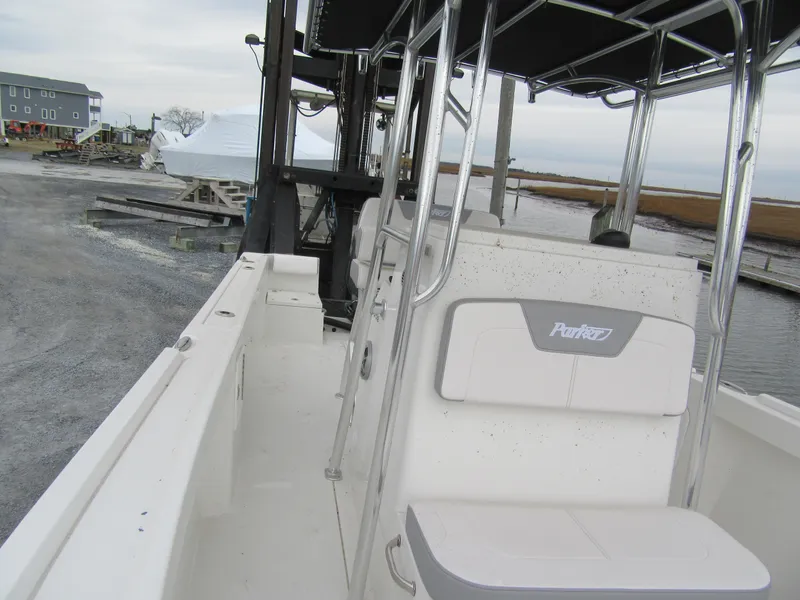 Slide: The Image of 2025 Parker 23SE Center Console boat docked, featuring sleek design and spacious seating. - 11