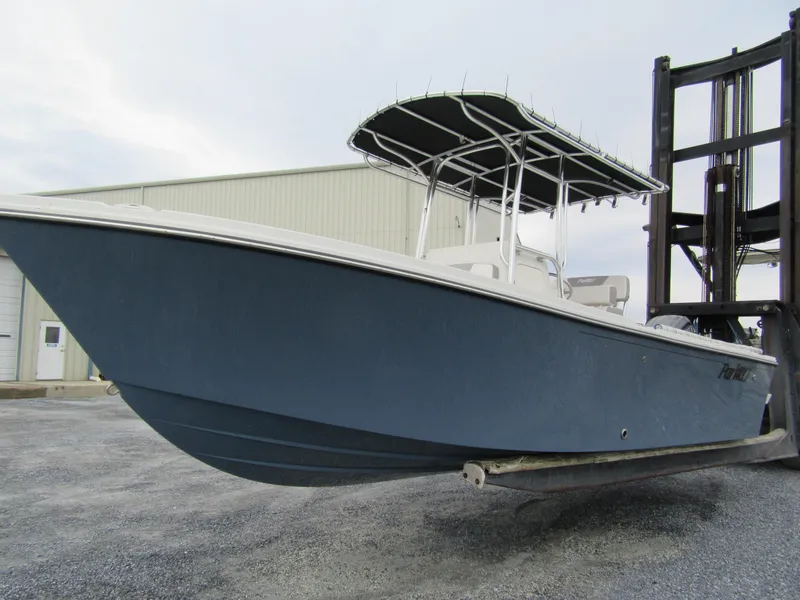 Slide: The Image of 2025 Parker 23SE Center Console boat on forklift, blue hull, outdoor storage. - 3