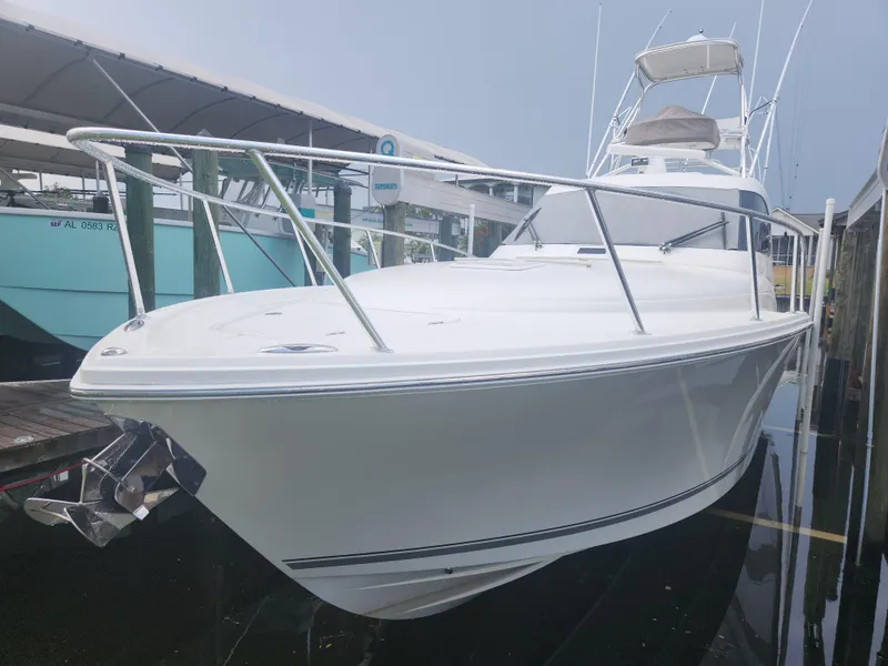 Slide: The Image of 2015 Jupiter 41 SB boat docked, showcasing sleek design and polished exterior. - 13