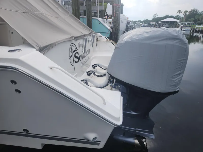 Slide: The Image of 2015 Jupiter 41 SB boat docked, featuring covered outboard motor and "Southbound" branding. - 14