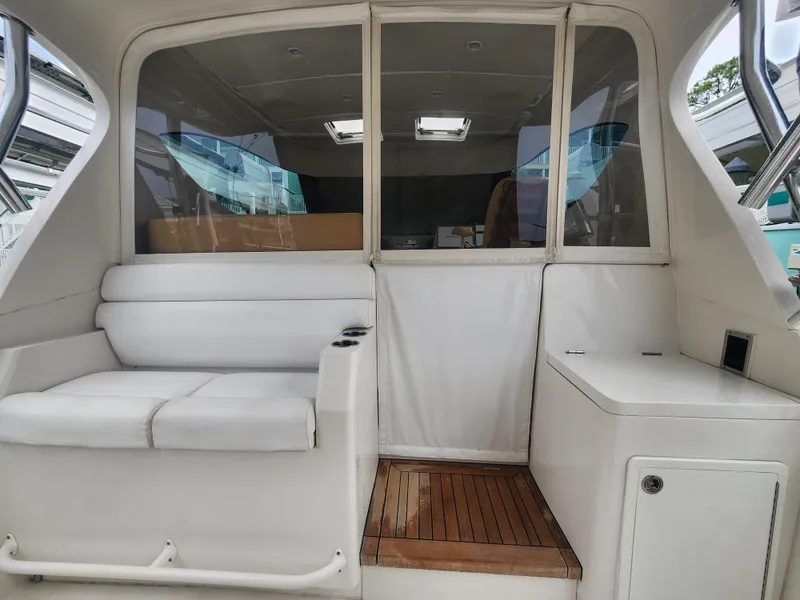 Slide: The Image of Interior view of 2015 Jupiter 41 SB boat with white seating and wooden flooring. - 19