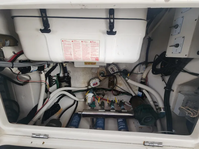 Slide: The Image of Engine compartment of a 2015 Jupiter 41 SB boat, showcasing various mechanical components. - 23