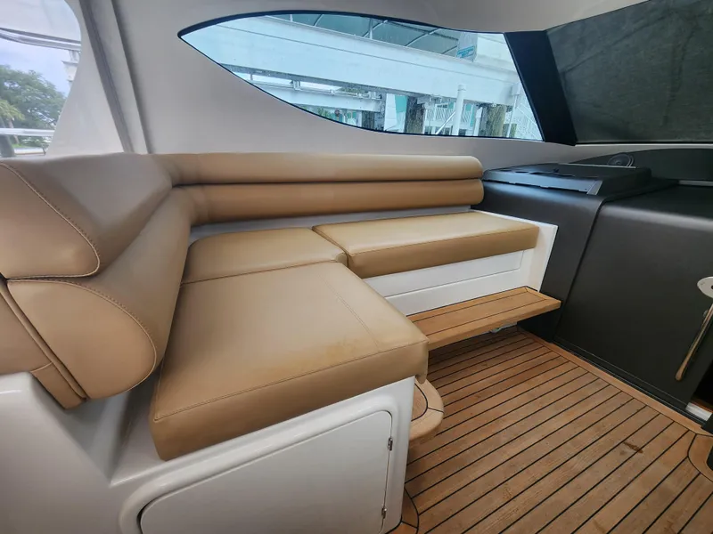 Slide: The Image of Luxurious interior seating of 2015 Jupiter 41 SB yacht with tan leather and wood flooring. - 26