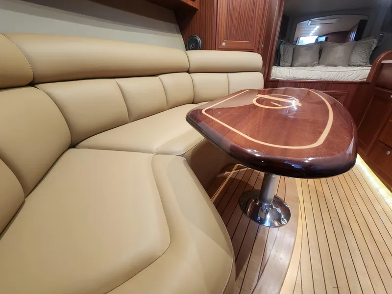 Slide: The Image of Luxurious interior of 2015 Jupiter 41 SB yacht with leather seating and wooden table. - 28