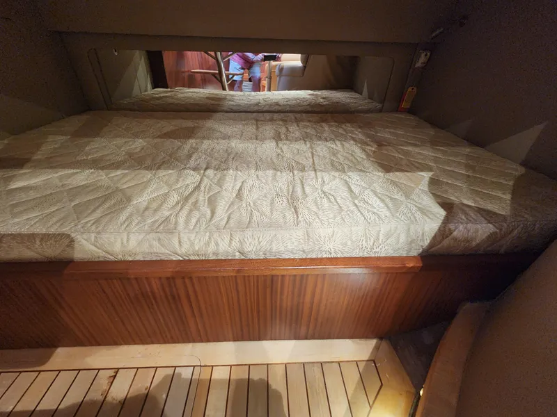 Slide: The Image of Interior cabin of 2015 Jupiter 41 SB with a neatly made bed. - 32