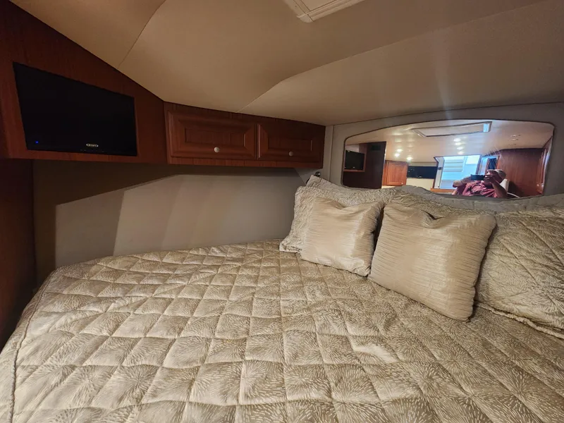 Slide: The Image of Luxurious cabin interior of 2015 Jupiter 41 SB with plush bedding and wooden cabinetry. - 35