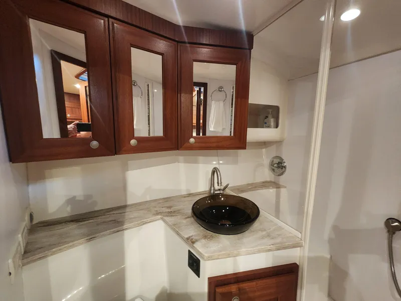Slide: The Image of Luxurious bathroom interior of 2015 Jupiter 41 SB yacht with elegant wood cabinetry. - 40