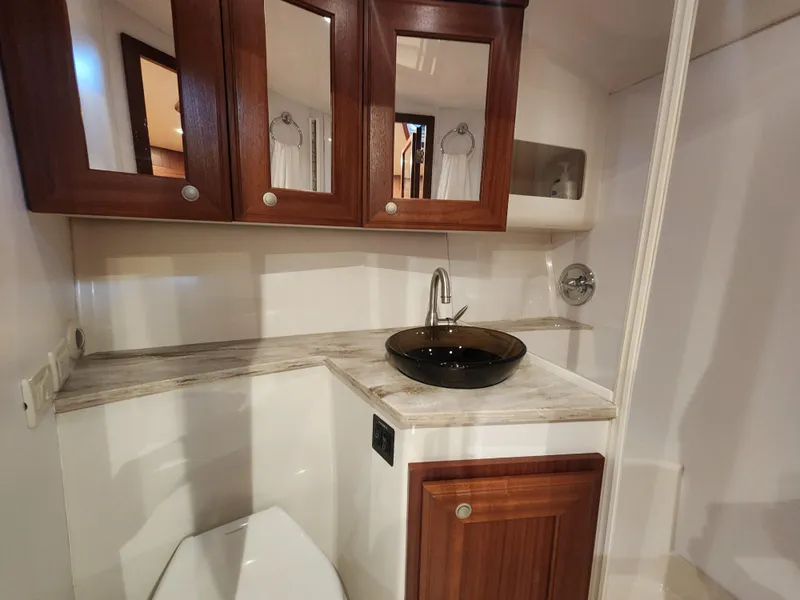 Slide: The Image of Luxurious bathroom in 2015 Jupiter 41 SB yacht with elegant wood cabinetry. - 42