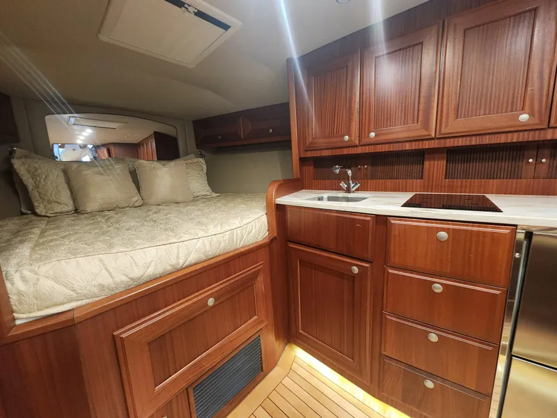 Slide: The Image of Luxurious interior of 2015 Jupiter 41 SB yacht with wood cabinetry and cozy sleeping area. - 45