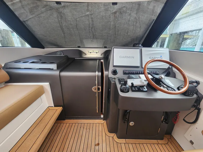 Slide: The Image of Helm of 2015 Jupiter 41 SB boat with Garmin navigation system and wooden steering wheel. - 47