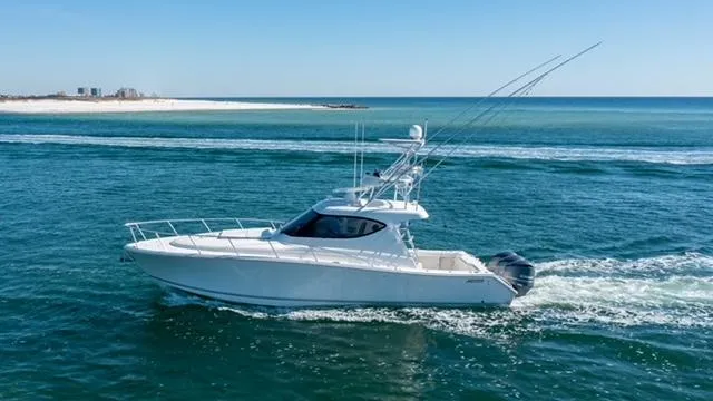 Slide: The Image of 2015 Jupiter 41 SB yacht cruising on open sea near sandy coastline. - 5