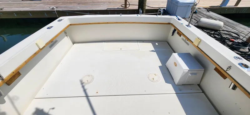 Slide: The Image of 1988 Tiara Yachts 2700 Open boat deck, spacious and well-maintained, docked at marina. - 10