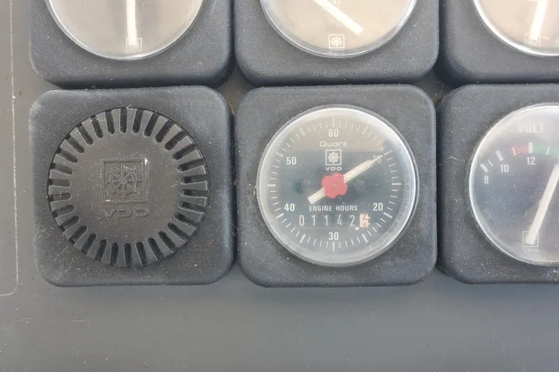 Slide: The Image of Dashboard gauges of a 1988 Tiara Yachts 2700 Open, showing engine hours and voltmeter. - 11