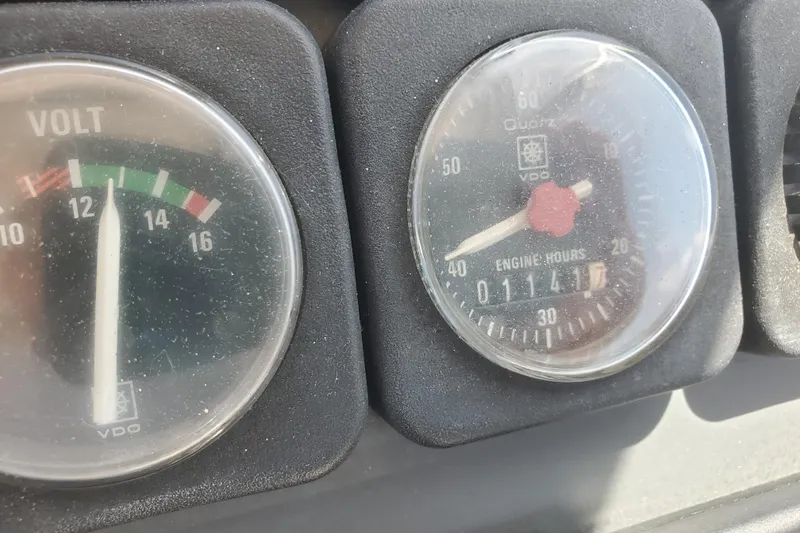 Slide: The Image of Close-up of 1988 Tiara Yachts 2700 Open dashboard gauges showing voltmeter and engine hours. - 12