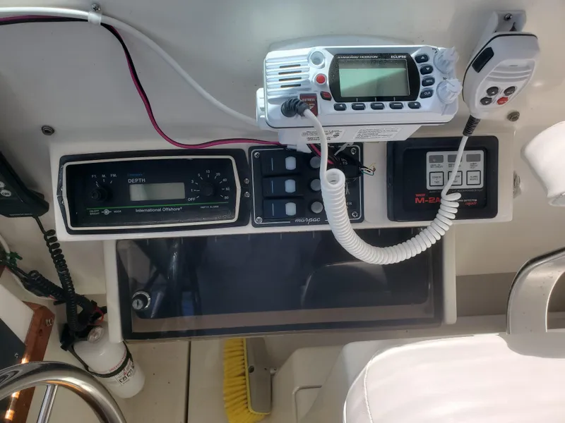 Slide: The Image of Control panel of a 1988 Tiara Yachts 2700 Open with radio and navigation equipment. - 13