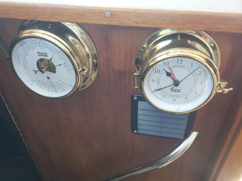 Slide: The Image of Brass clock and barometer on 1988 Tiara Yachts 2700 Open wooden panel. - 20