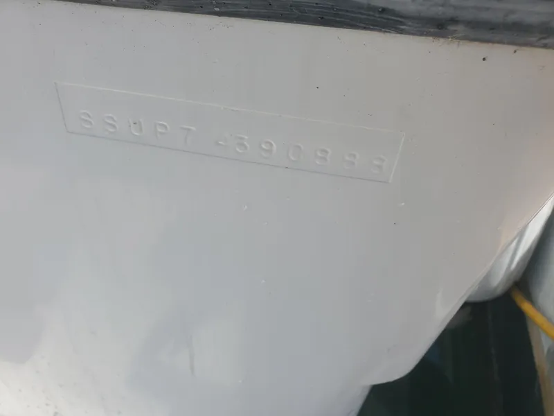 Slide: The Image of 1988 Tiara Yachts 2700 Open hull identification number embossed on white surface. - 23