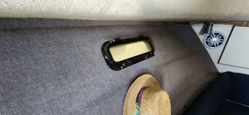 Slide: The Image of Interior of 1988 Tiara Yachts 2700 Open, featuring a window and straw hat. - 30