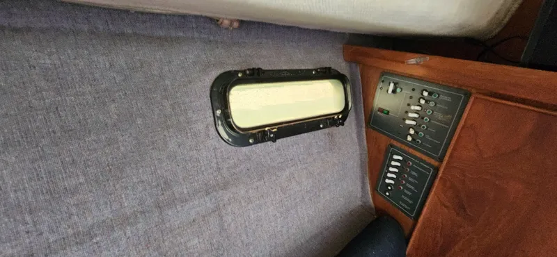 Slide: The Image of 1988 Tiara Yachts 2700 Open cabin interior with control panel and porthole. - 31