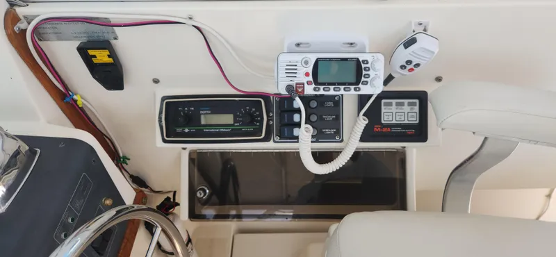Slide: The Image of 1988 Tiara Yachts 2700 Open dashboard with marine radio and controls. - 36