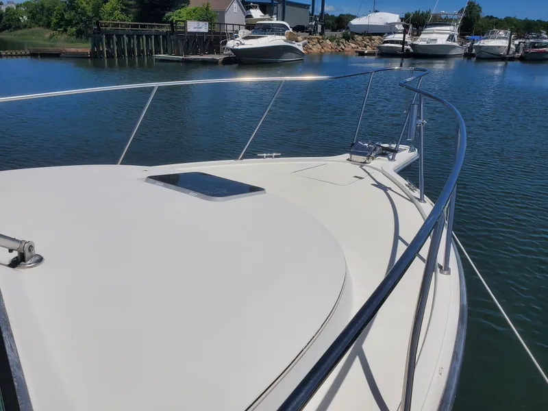 Slide: The Image of 1988 Tiara Yachts 2700 Open boat docked in a serene marina setting. - 4