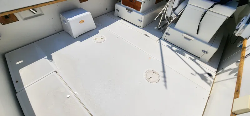 Slide: The Image of 1988 Tiara Yachts 2700 Open boat deck with storage compartments and seating. - 8