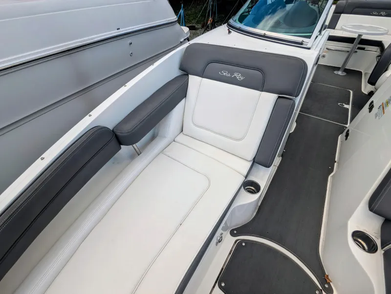 Slide: The Image of 2011 Sea Ray 260 Sundeck interior with white and gray seating, cup holders, and sleek design. - 10