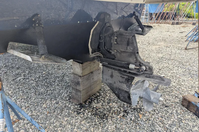 Slide: The Image of 2011 Sea Ray 260 Sundeck outdrive on blocks, gravel background. - 18