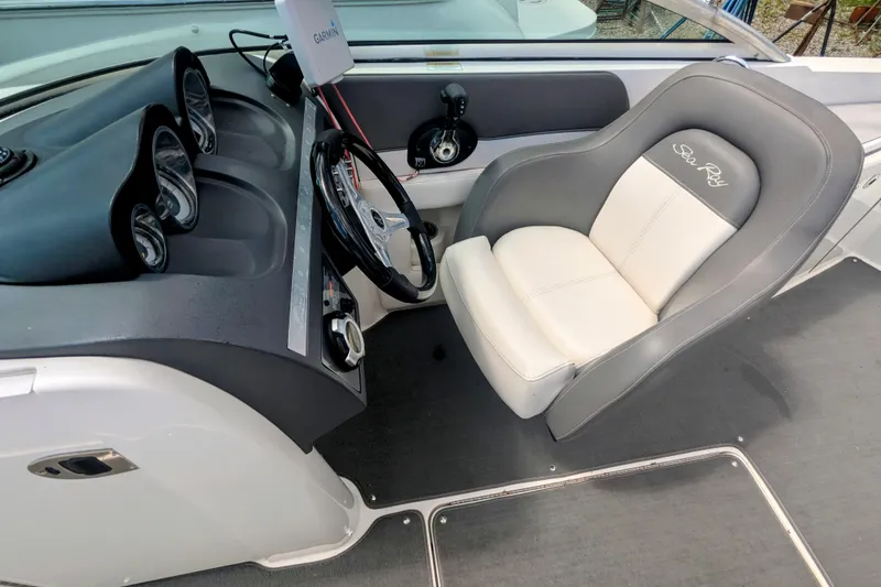 Slide: The Image of 2011 Sea Ray 260 Sundeck cockpit with steering wheel and comfortable seating. - 3